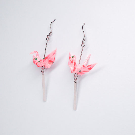 Pair of handmade pink origami crane earrings with silver bar accents and hooks, crafted from traditional Japanese washi paper