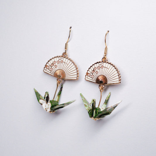 Pair of handmade green origami crane earrings with gold fan charms and hooks, crafted from traditional Japanese washi paper