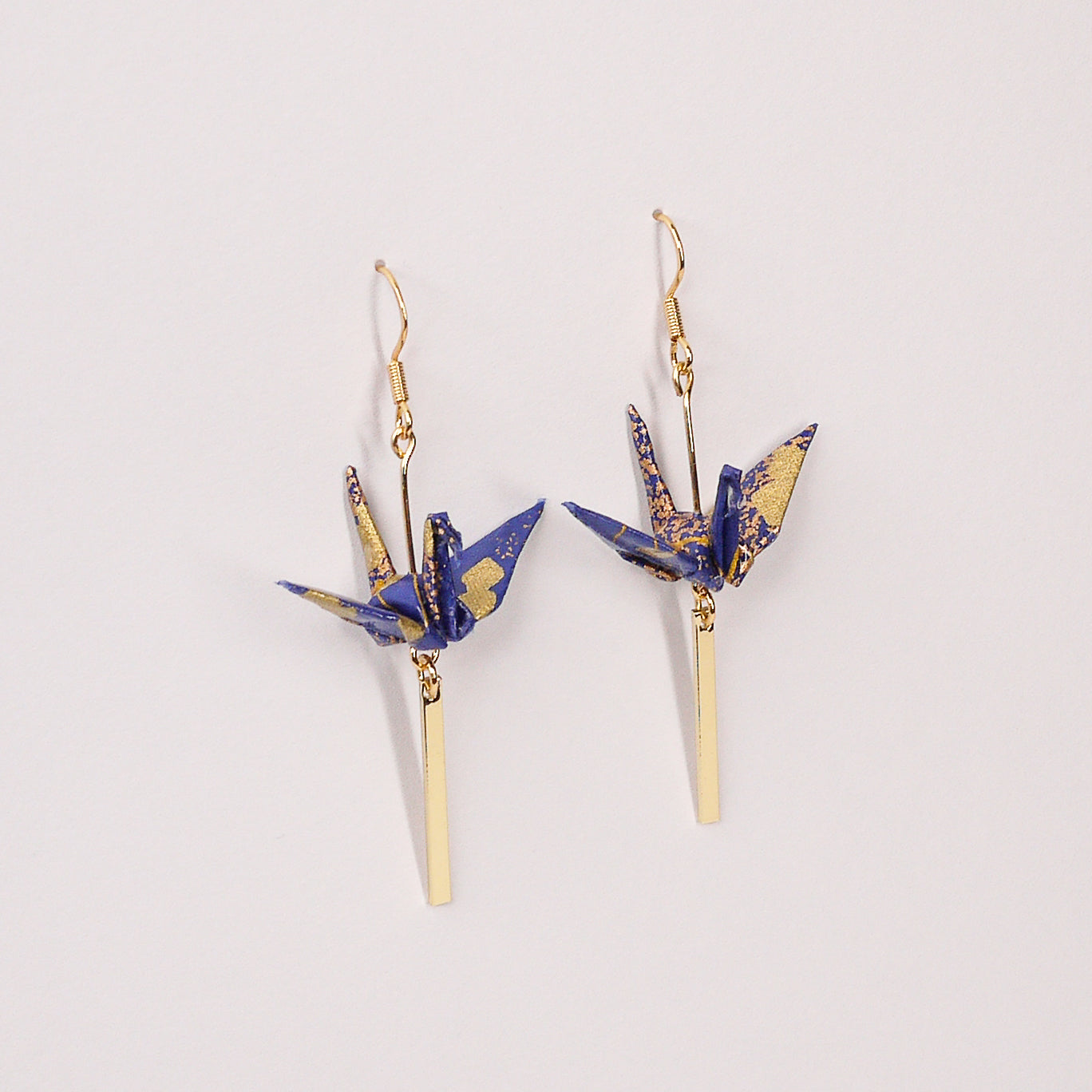 Pair of handmade royal blue origami crane earrings with gold cloud print, gold bar and hooks, crafted from traditional Japanese washi paper. main view