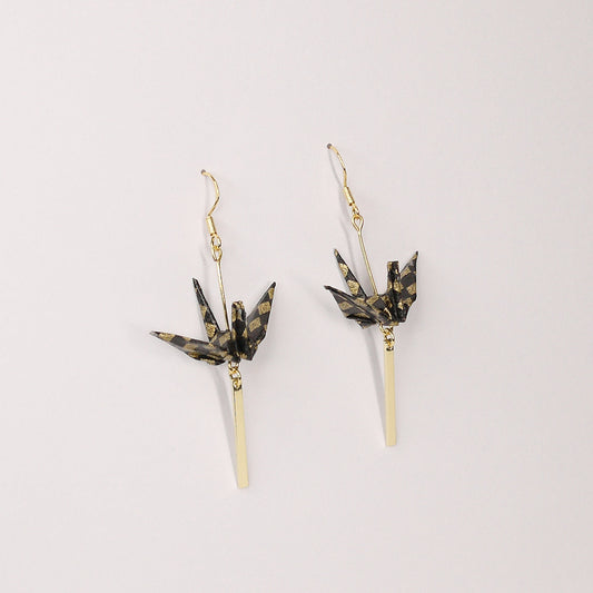 Pair of handmade black origami crane earrings with gold checkered print, gold bar and hooks, crafted from traditional Japanese washi paper. main view