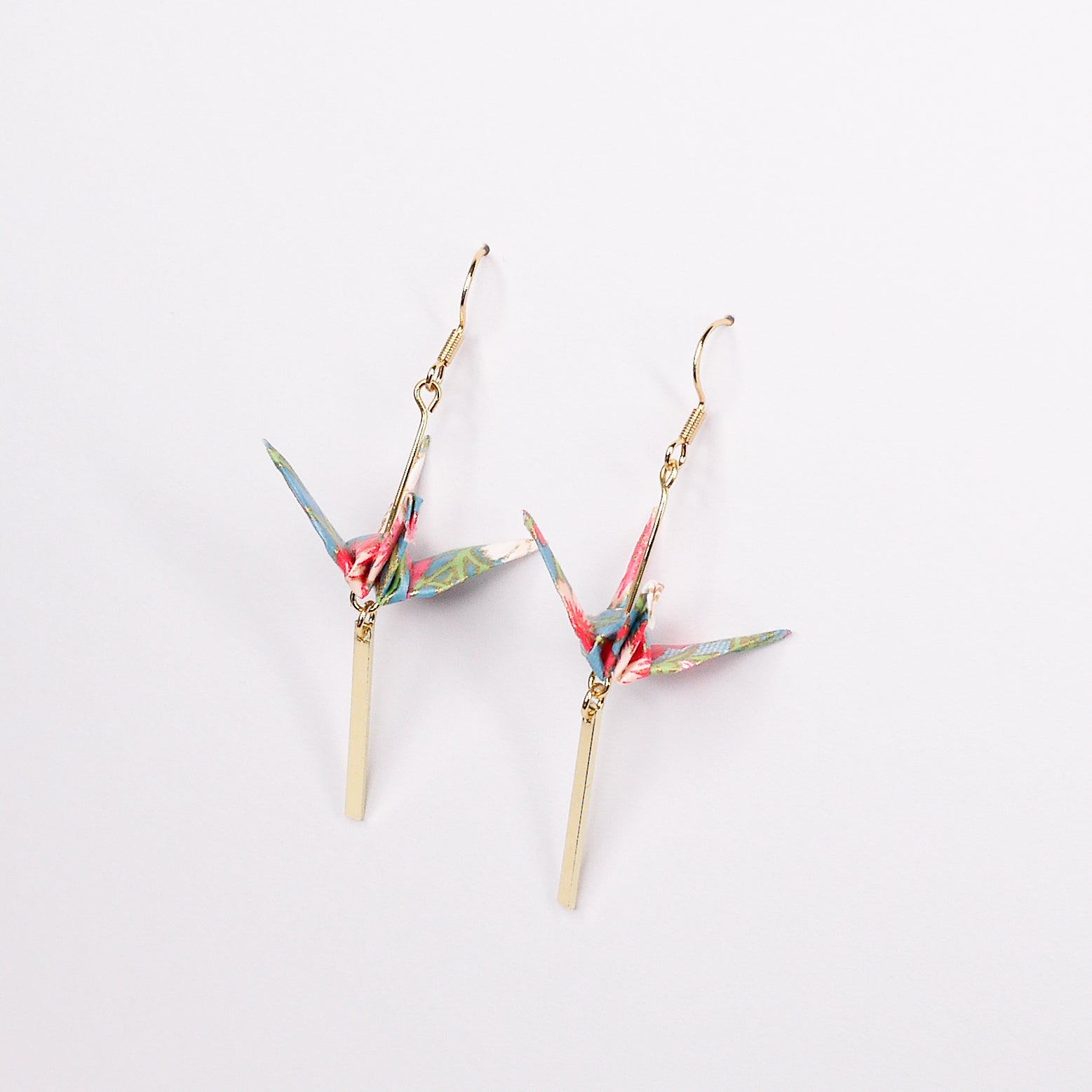 Pair of handmade blue origami crane earrings with flower stalk print, gold bar and hooks, crafted from traditional Japanese washi paper. front view