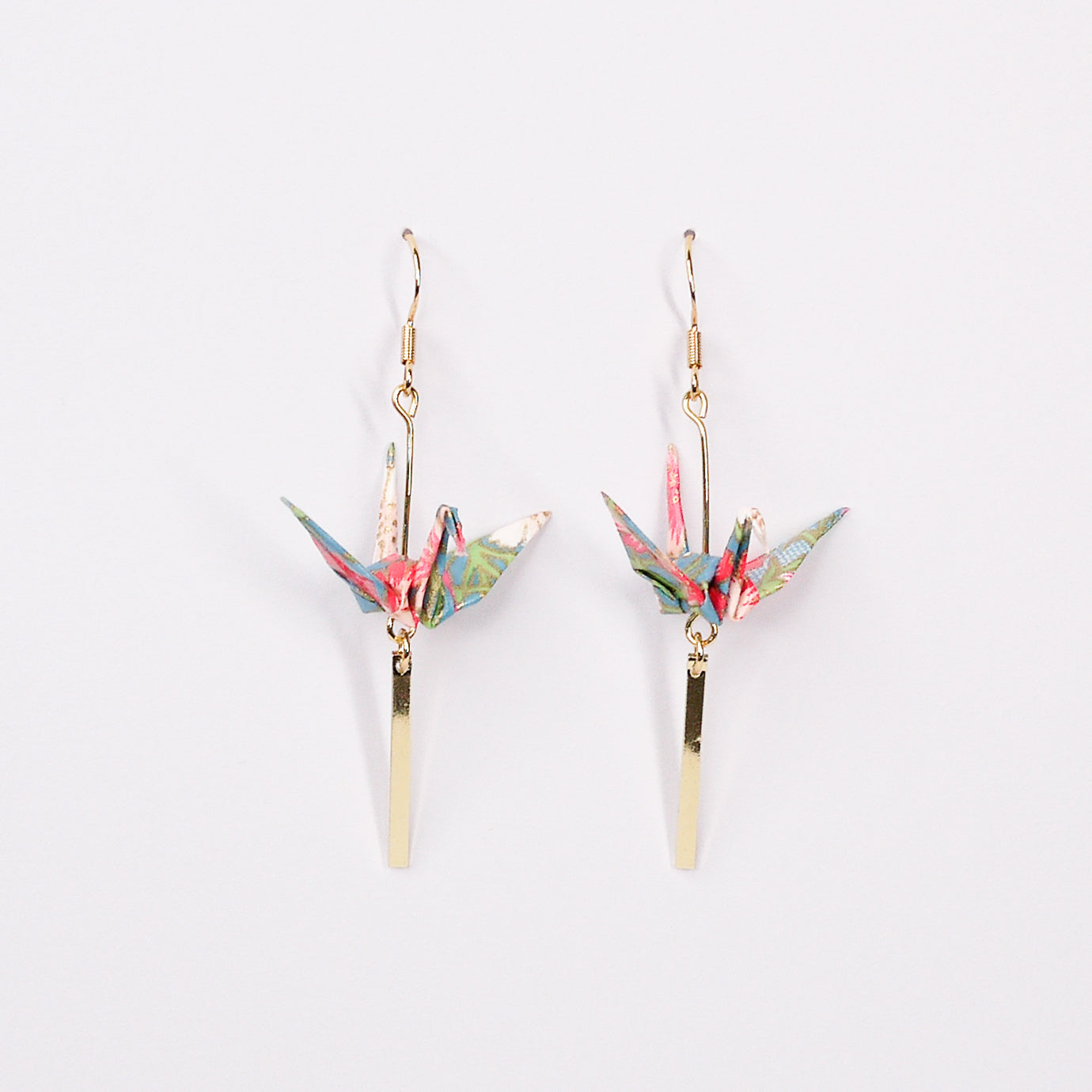 Pair of handmade blue origami crane earrings with flower stalk print, gold bar and hooks, crafted from traditional Japanese washi paper. side view