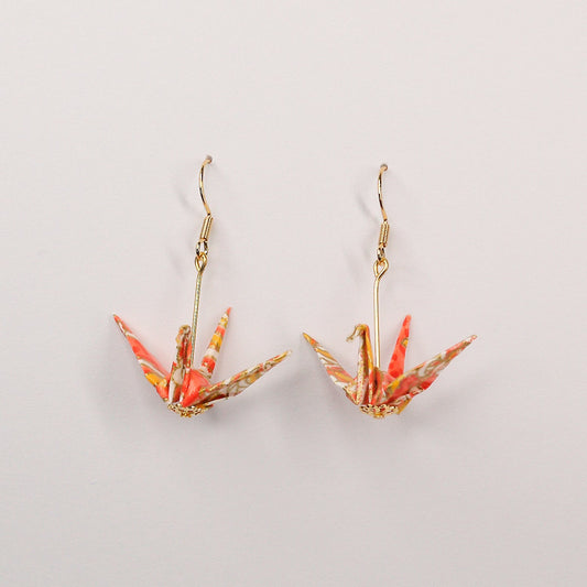 Pair of handmade orange origami crane earrings with chrysanthemum floral print and gold hooks, crafted from traditional Japanese washi paper. main view