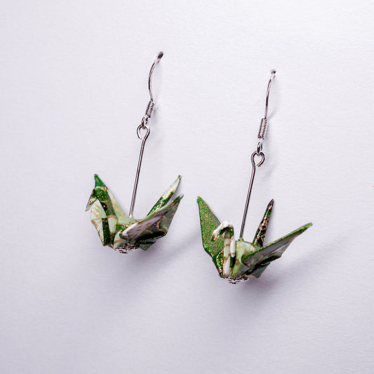 Pair of handmade green origami crane earrings with flower prints and hooks, crafted from traditional Japanese washi paper. side view