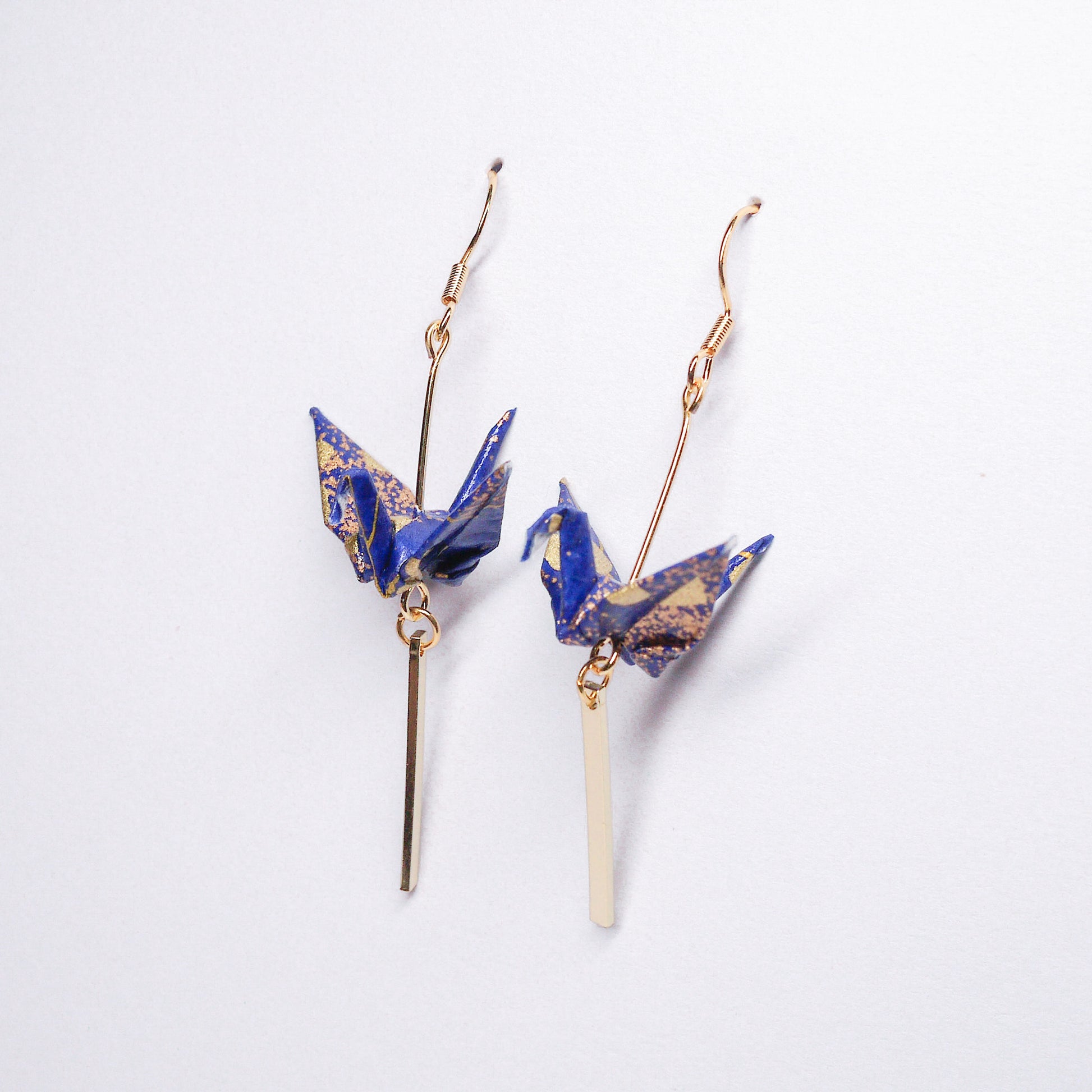 Pair of handmade blue origami crane earrings with gold bar and hooks, crafted from traditional Japanese washi paper