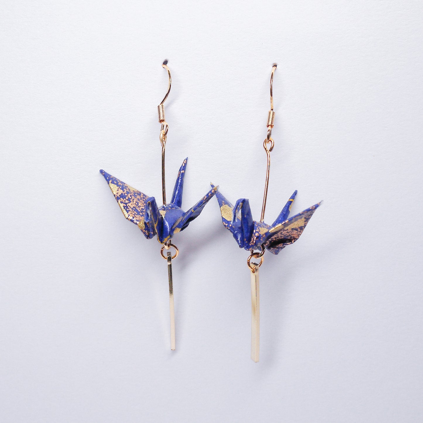 Pair of handmade blue origami crane earrings with gold bar and hooks, crafted from traditional Japanese washi paper