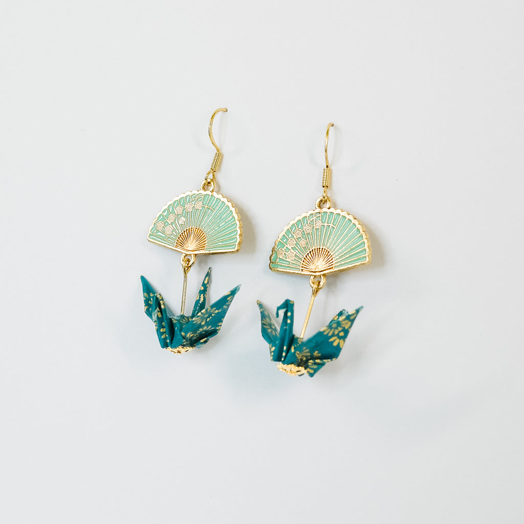 Teal and gold origami crane earrings with fan design on a light gray background