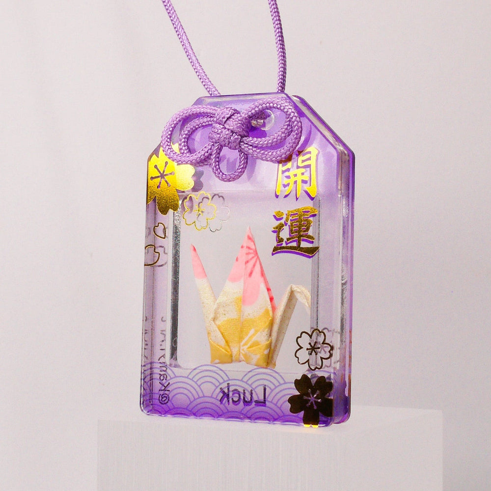 Purple decorative item with floral designs and text on a light gray background